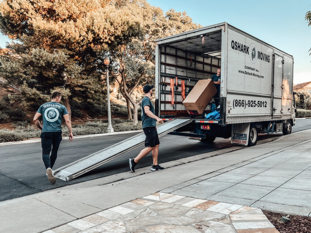 Qshark Movers loading our company truck, to deliver items to customer's self-storage facility