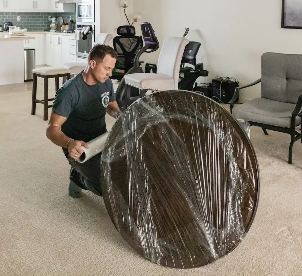 worker securing furniture for transport