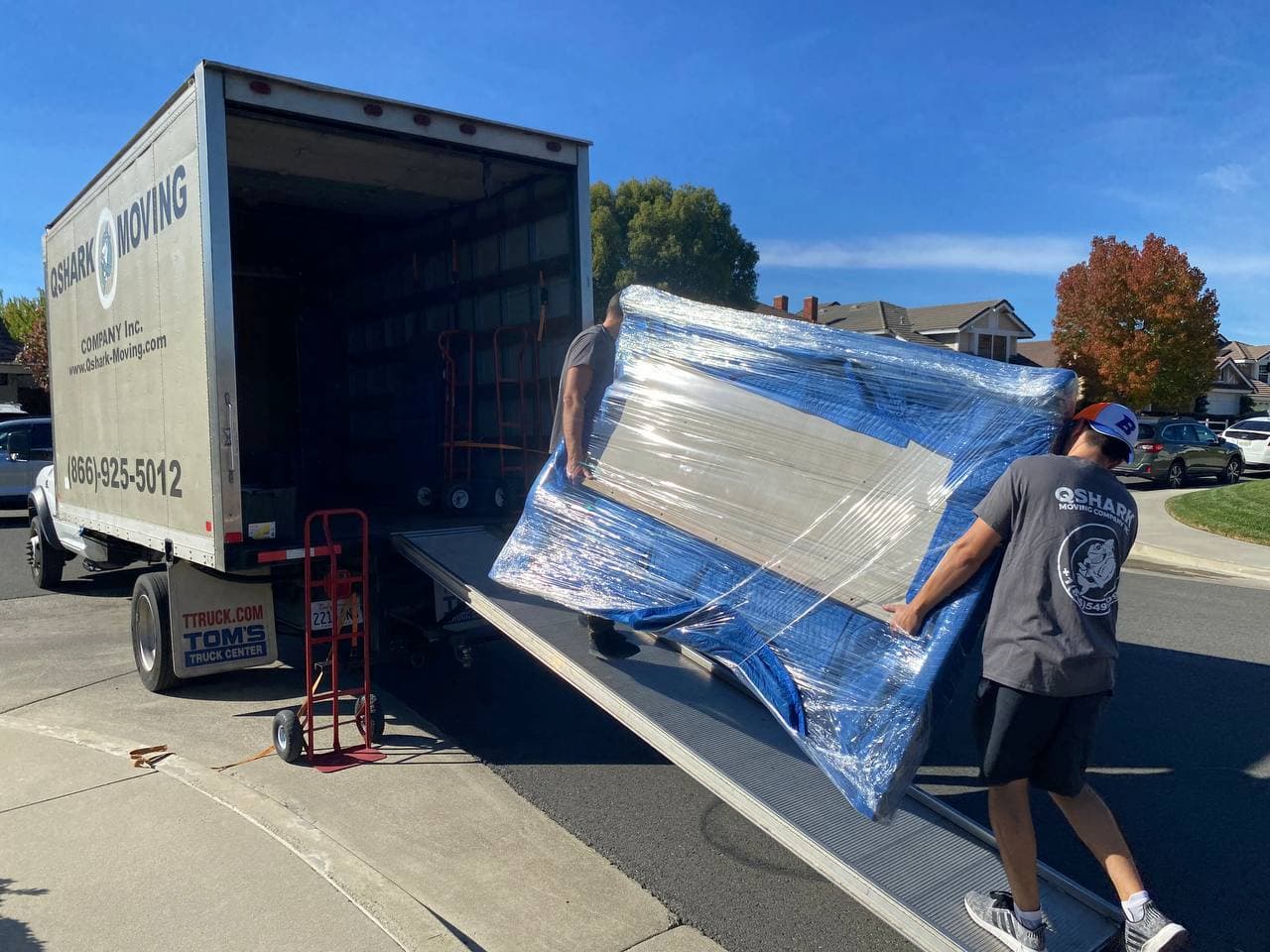 Team of movers handling large items with care