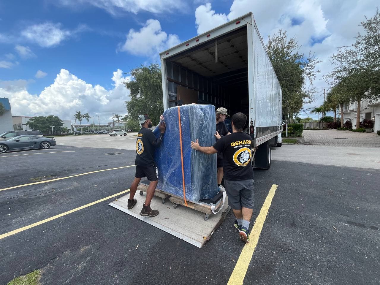Professional movers preparing furniture for transport