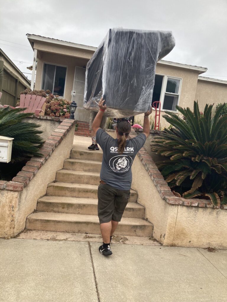 movers moving a couch up the stairs