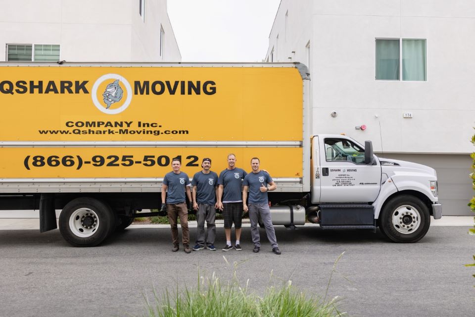a picture of qshark movers next to qshark moving truck 