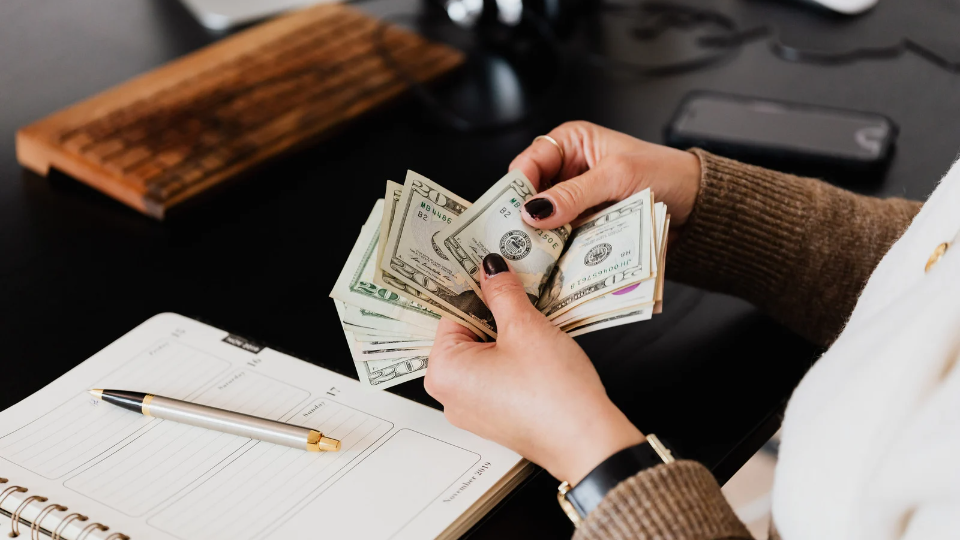 a picture of a person counting money