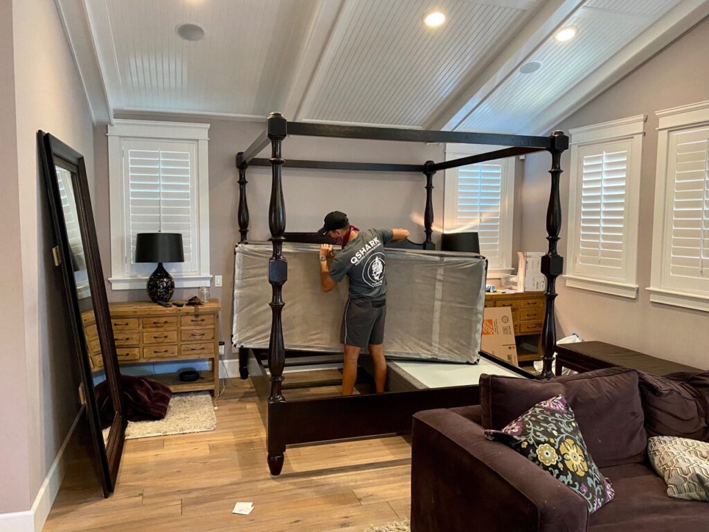 a picture of a mover moving a mattress