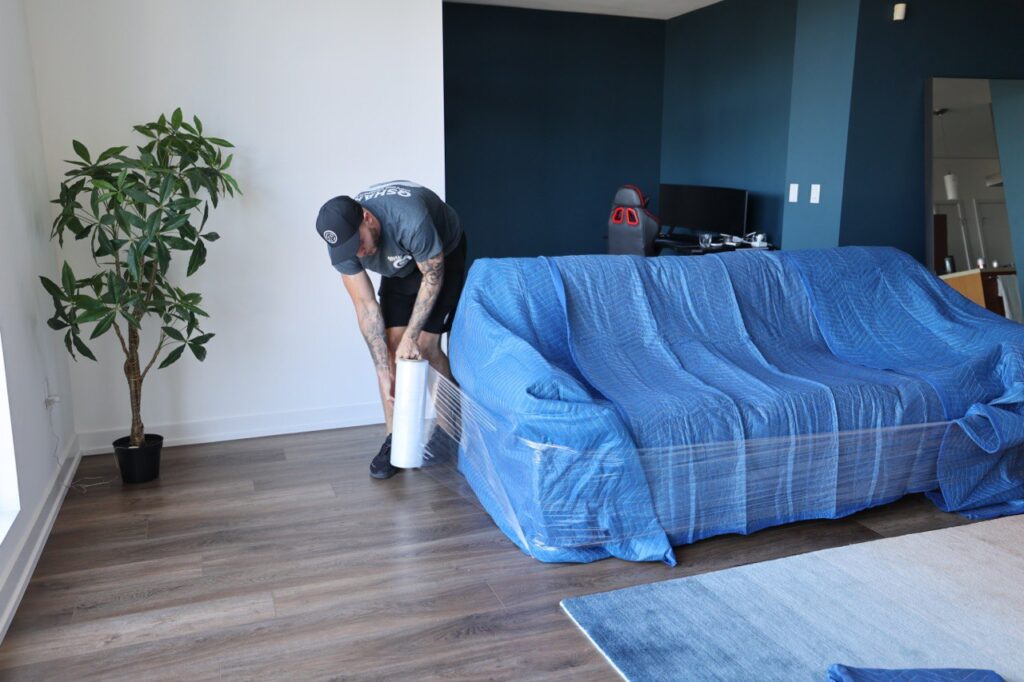 a picture of a movers packing a couch 