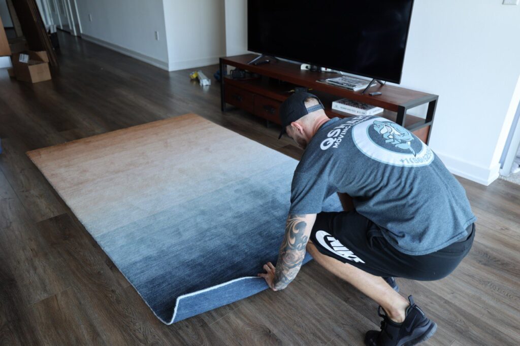 a mover packing a rug