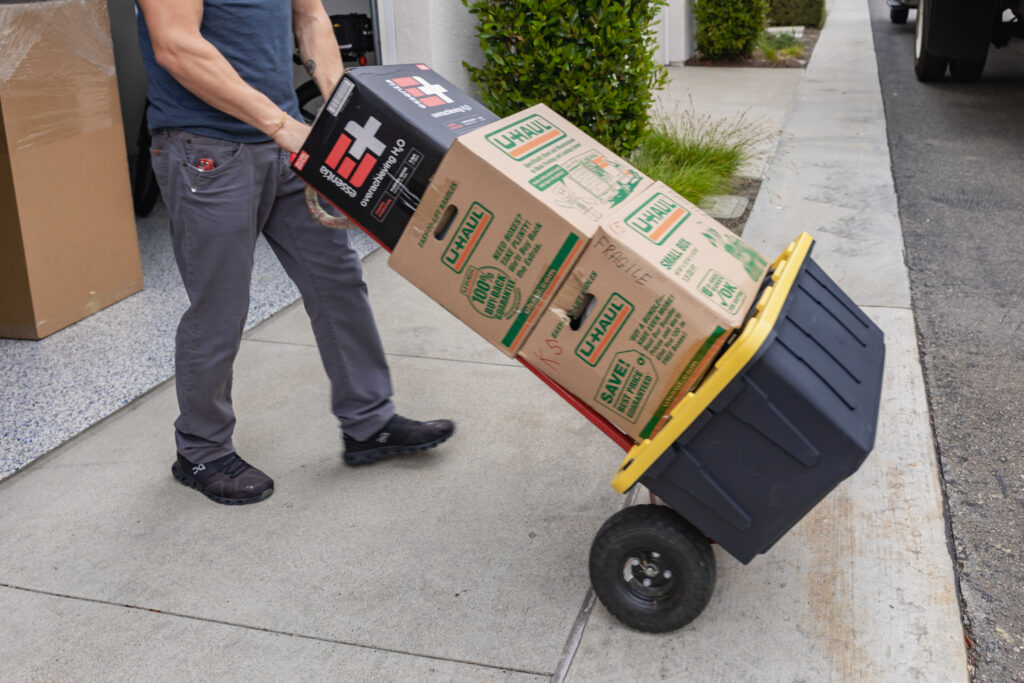 a picture of qshark mover moving boxes using a dolly