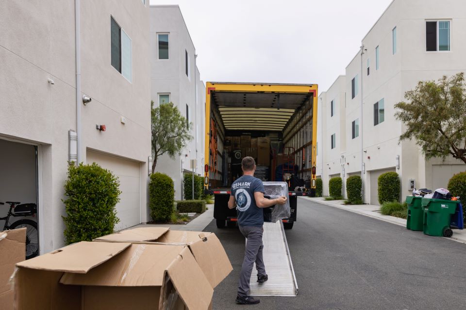 a picture of qshark movers loading a moving truck
