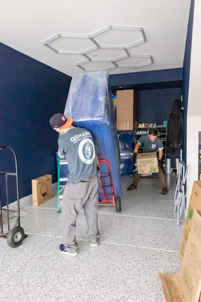 a picture of qshark movers unloading a moving truck
