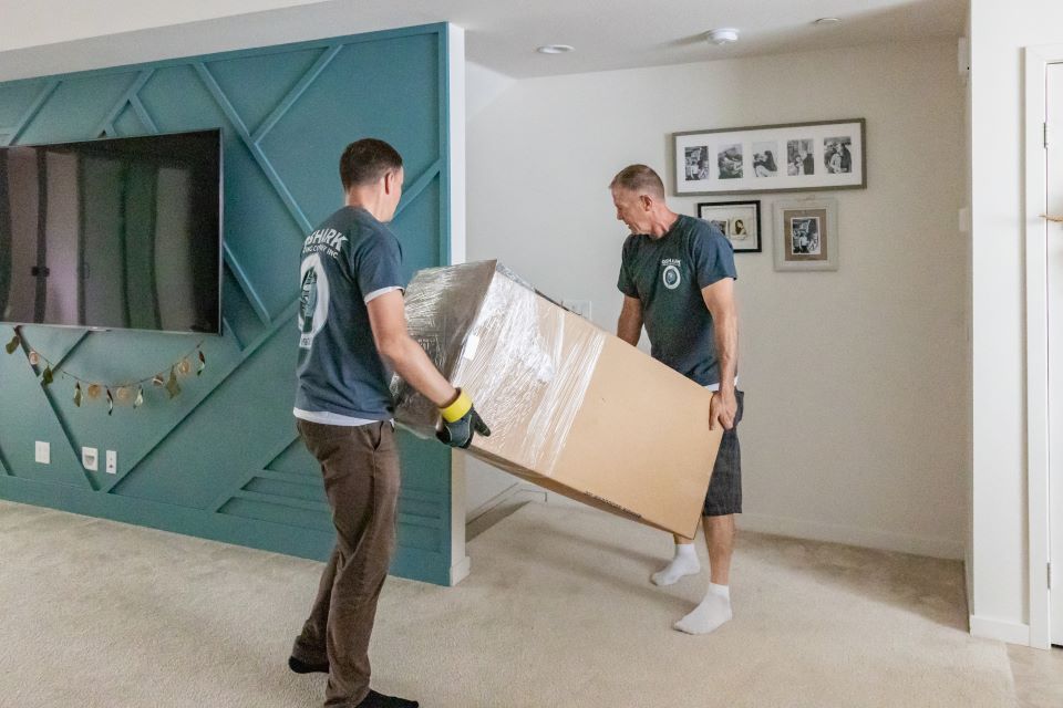 qshark movers moving a dresser downstairs