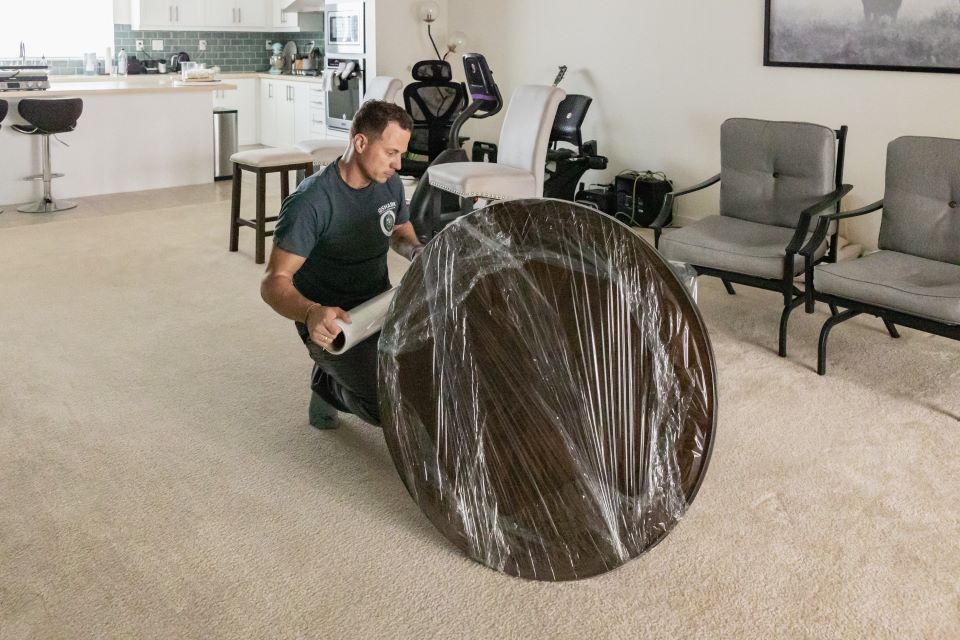 a picture of a qshark mover packing a coffee table