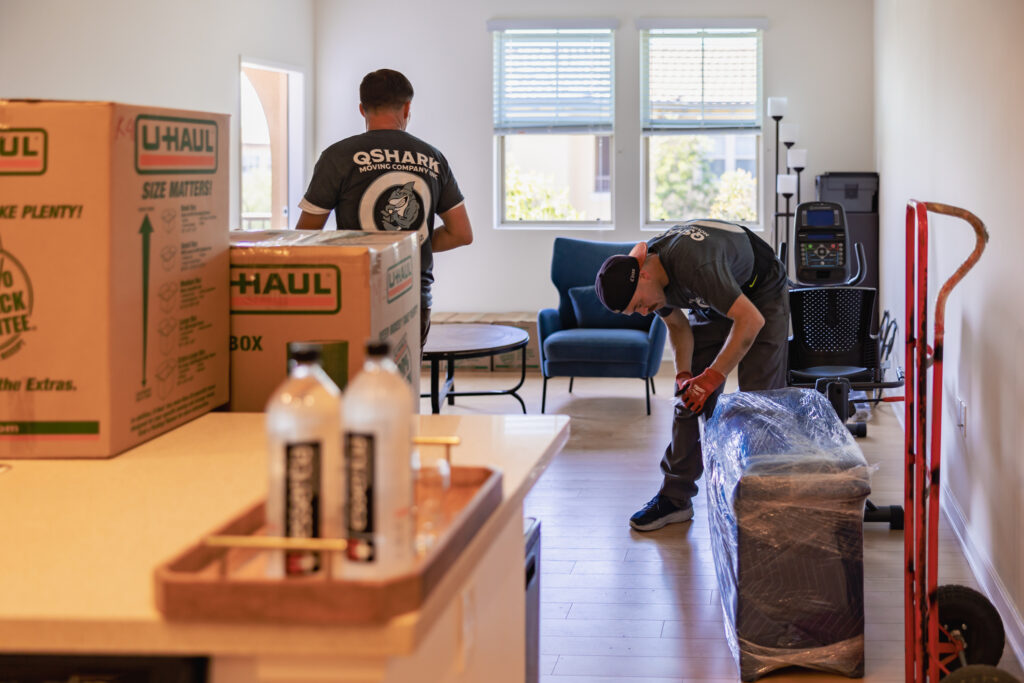 qshark movers using shrink wrap to protect furniture