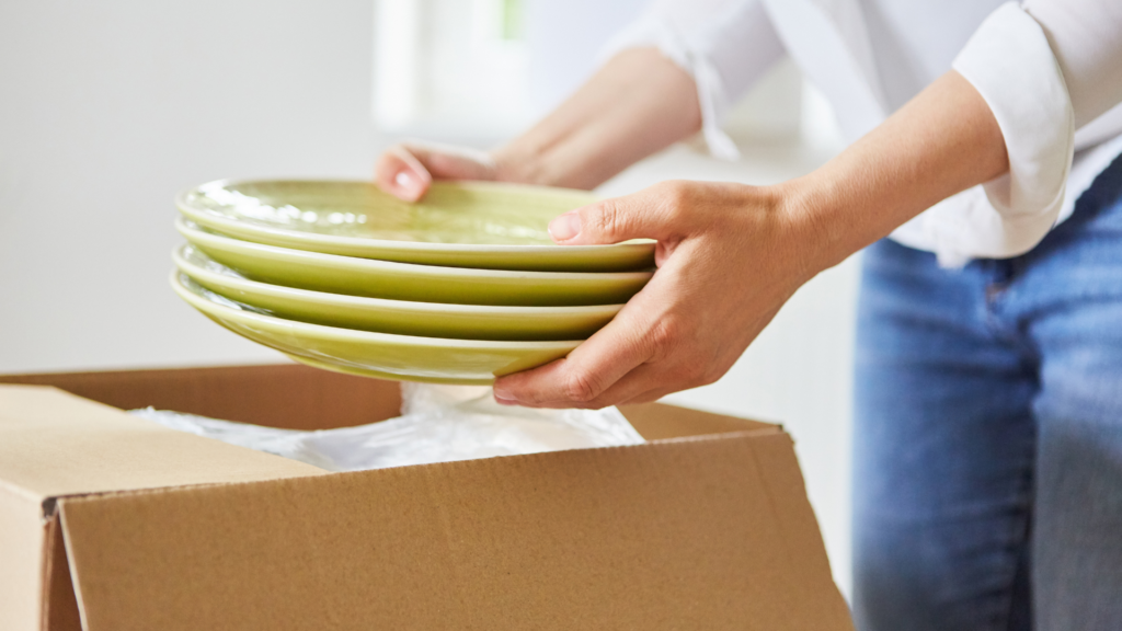 a picture of a person packing dishes