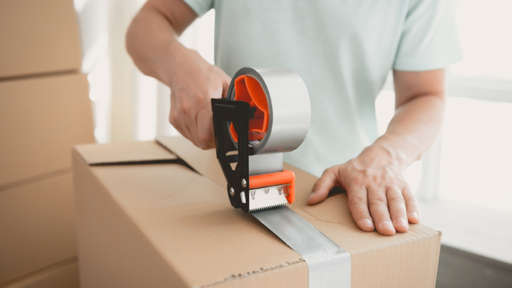 a person packing knives into a box