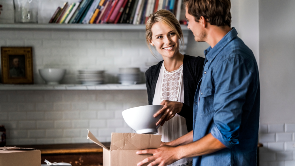 a happy couple packing bowls into the boxes using our how to guide