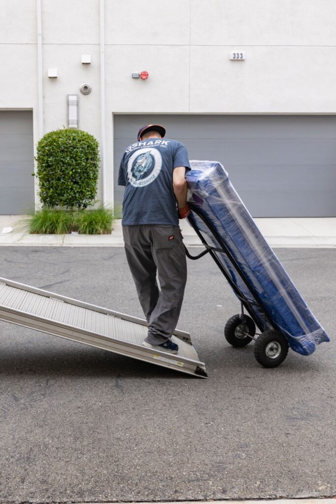 qshark mover using a dolly to move an item on the ramp