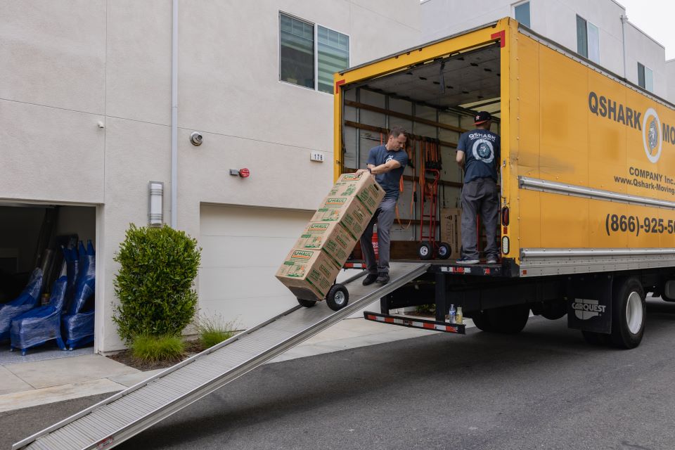a picture of qshark moving truck and movers, shwong the cost of moving in los angeles