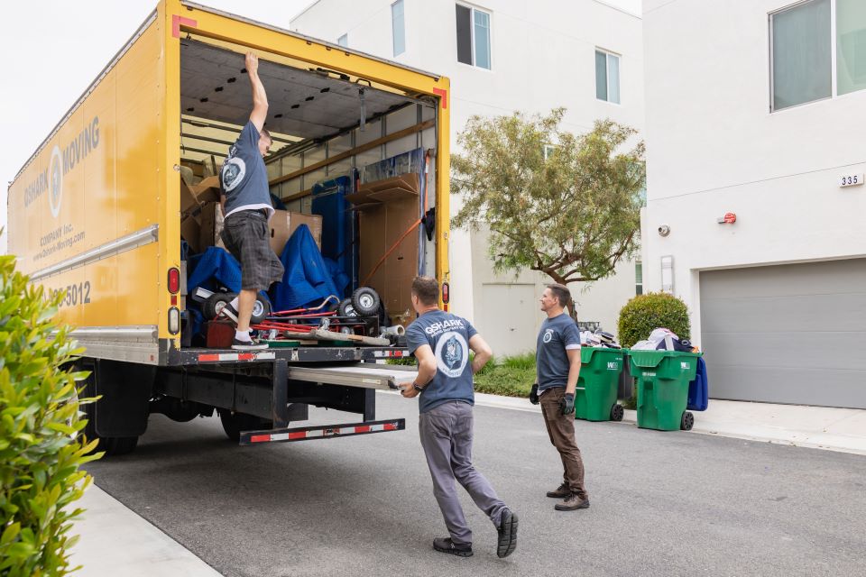 What Do Most Movers Charge Per Hour? a picutre of qshark movers loading a moving truck