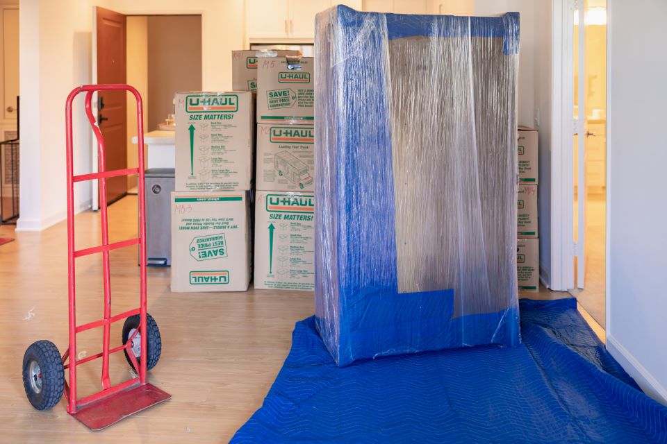 a picture of prepared couch and boxes for moving with Qshark Moving Company