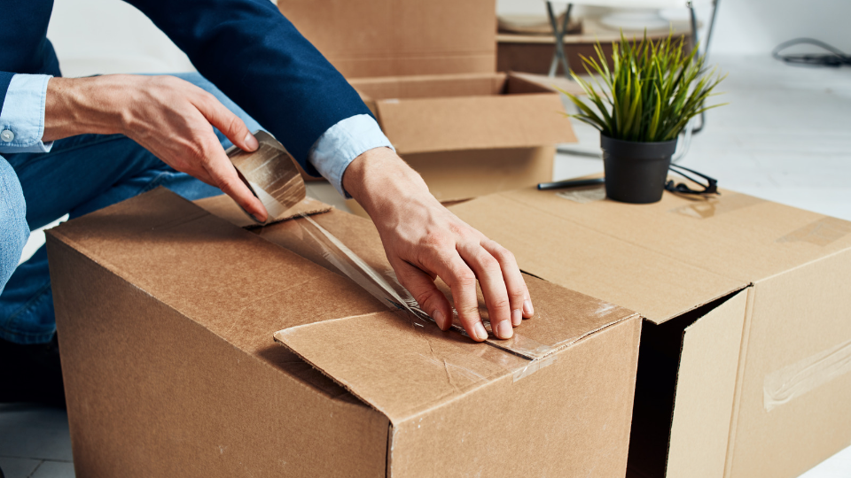 a person who packing and sealing the box