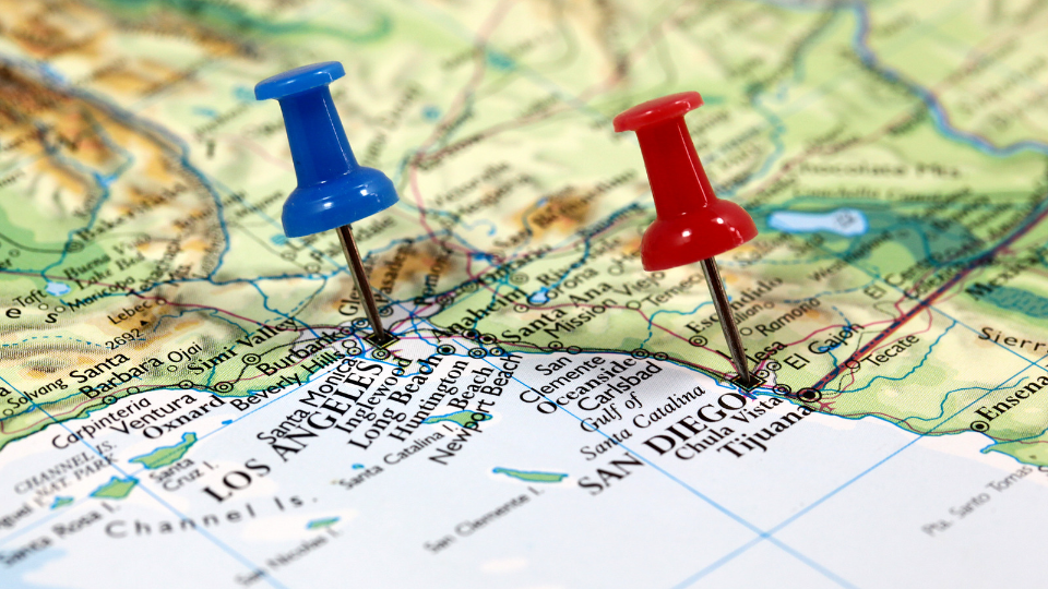 a picture of two pins showing san diego and la on the map