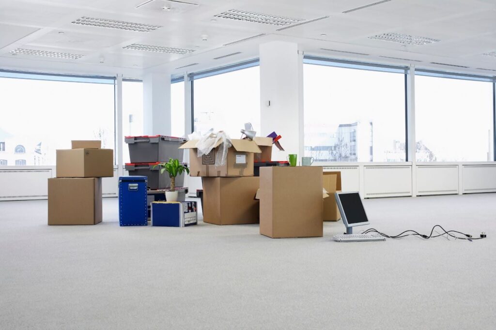 Cartons and equipment on the floor of an empty office space