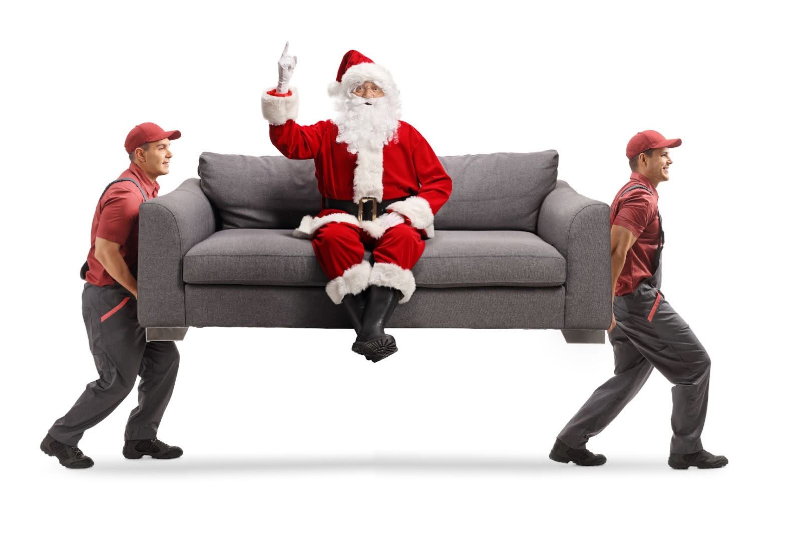 Movers carrying a sofa with santa claus sitting on it