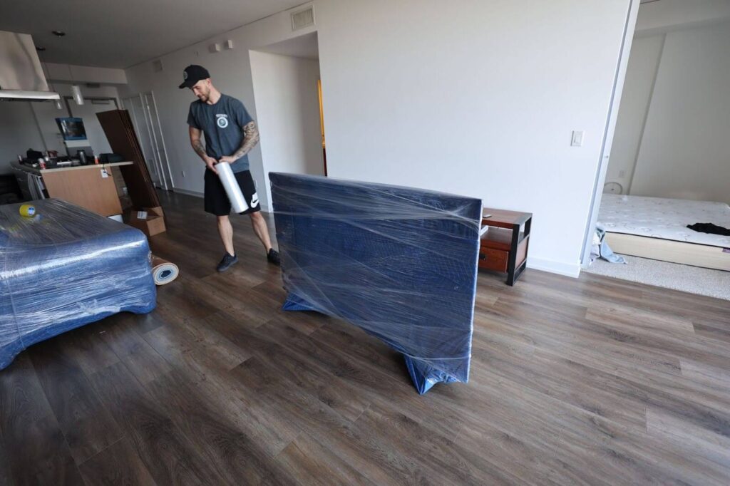 Qshark mover packing a TV with bubble wrap