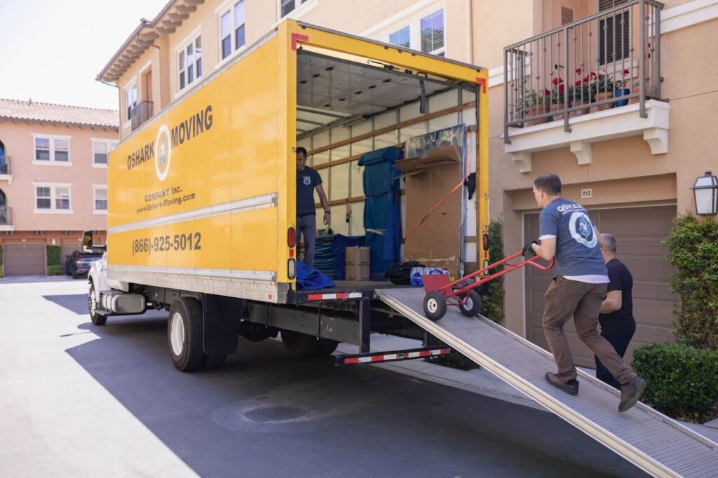 Qshark movers taking out a dolly from their truck